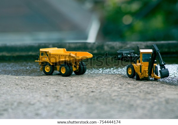 A yellow truck with fork lake under\
construction in a water-filled city\
\
\
center.