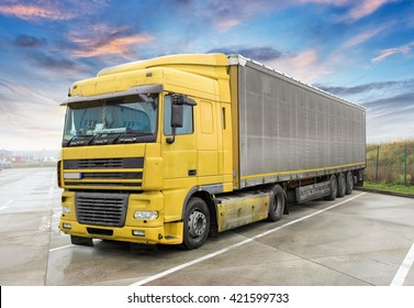 Yellow Truck On Road. Cargo Transportation