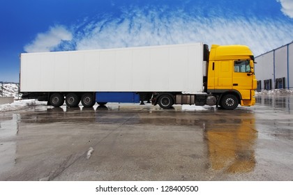 Yellow Truck Standing  On A Parking