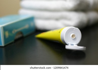 Yellow Tube Of Diaper Rash Cream With Aqua Q-tip Box And White Towels