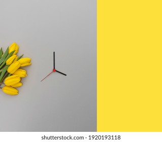 Yellow Tulips And Clock Hands On A 2021 Color Backdrop. Spring Time Change Concept.