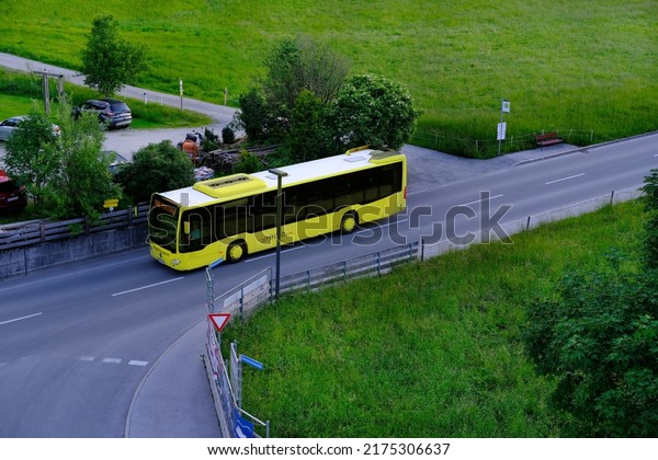 yellow\
Tyrol public transport buses, roads in valley of mountain villages\
near Achensee lake in Austria, concept of transportation, tourism,\
active lifestyle, Pertisau, Austria - June\
2022