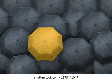 Yellow umbrella stand out from the crowd. Leader concept.