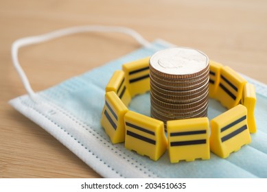 Yellow Under Construction Barrier Around Stacked Coins On Mask. World Economy Crisis Due To COVID-19, Fix Repair Or Reset Investment Plan, Money Saving Management. Business Financial Crisis Concept.