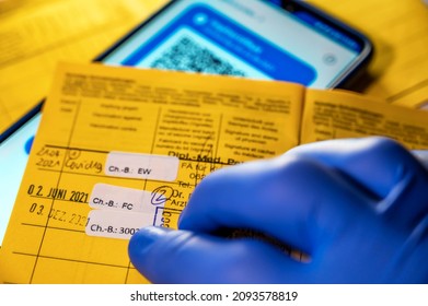 Yellow Vaccination Card And Digital Vaccination Card On A Smartphone