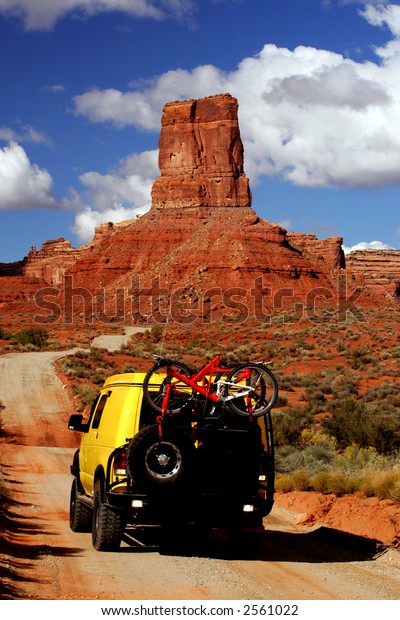 Yellow\
Van with Mountain bikes in Valley of Gods,\
Utah