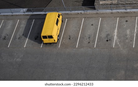 yellow van is standing in an empty parking lot. delivery and transportation of goods
