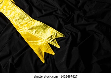 Yellow Velvet Winner Sash For Miss Pageant Beauty Contest, Empty Area For Text Winner Country Word, Studio Lighting Abstract Dark Drapping Textile Background, Importance Decoration Shoulder To Waist