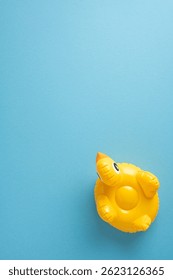 Yellow vertical inflatable pool float shaped as a duck on a minimalistic light blue surface