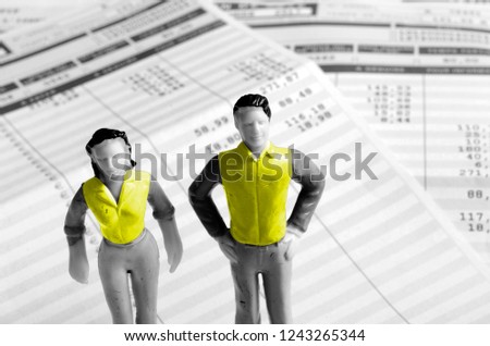 yellow vests man and woman minitature on pay sheets background, france