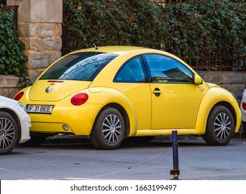 Yellow Volkswagen New Beetle Car Parked On A Street Of Bucharest, Romania, 2020.