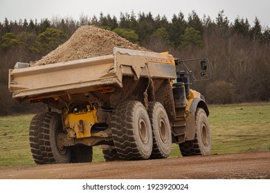 A Yellow Volvo A40E Articulated Dump Truck Earth Mover With Full 25 Tonne Payload Driving Across Salisbury Plain, Wiltshire UK