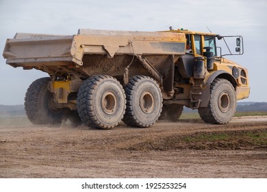 Yellow Volvo A40F Articulated Dump Truck Earth Mover On The Way To The Next 25 Tonne Load Driving Across Salisbury Plain, Wiltshire UK