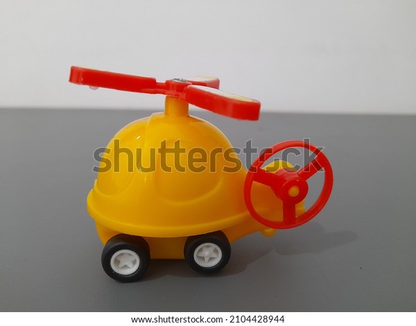 Yellow\
walking helicopter toy made of plastic\
material