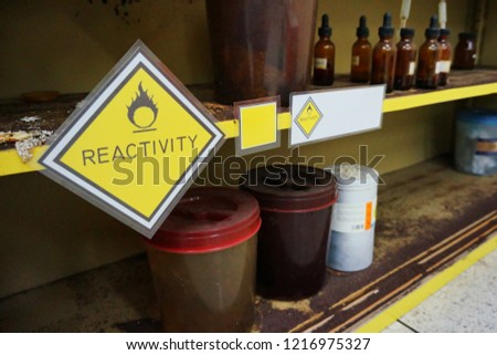 Yellow Warning Reactivity hazardous dangerous chemical label of oxidizing agent oxidant, oxidizer (substance that has the ability to oxidize other substances)  and effect of container were oxidized.