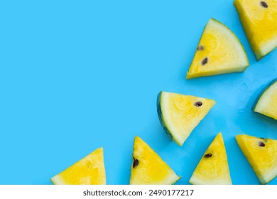 Yellow watermelon slices on blue background. - Powered by Shutterstock