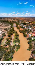 Yellow waters of Darling river near Wilcannia town on Barrier highway in outback australia - vertical aerial panorama.
