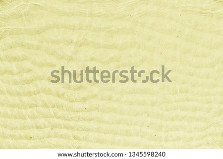 Yellow wave pattern on the sand in the sea.