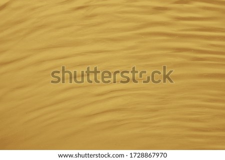 Yellow wavy striped background. Waves and ripples on the water. Place for text and design.