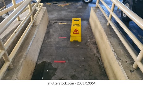 Yellow Wet Floor Sign At A Car Park Basement - Image Of Danger, Clean. Jakarta, 1 Desember 2021.