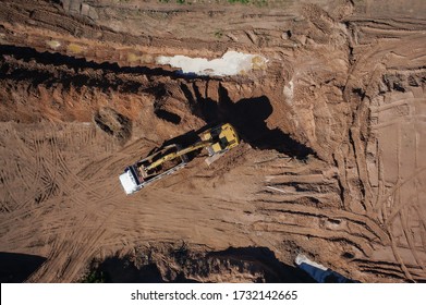 Yellow Wheel Loader Loading Sand On Dumper Truck . (zenith View)