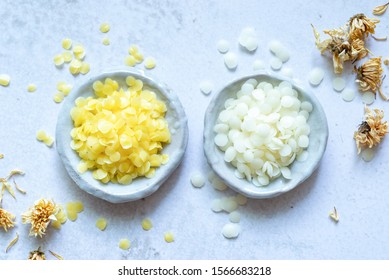 Yellow And White Cosmetic Beeswax Pellets In White Ceramic Bowl For Homemade Natural Beauty And D.I.Y. Project.