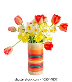 Yellow and white daffodils flowers, red orange tulips in a colored vase, flowerpot, close up, white background