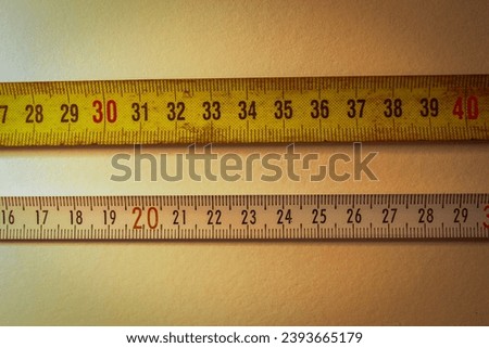 Yellow and white measure tape with centimetres.