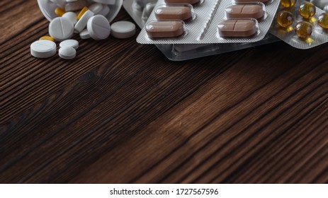 Yellow and white pills scattered from the jar. Nearby are pills in a bister. The concept of epidemic and protection against virus. Copy space - Shutterstock ID 1727567596