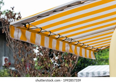 yellow and white striped awning of food truck shop.