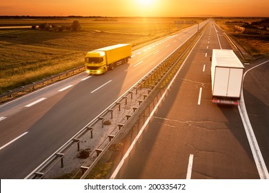 Yellow And White Truck In Motion Blur On The Highway At Sunset