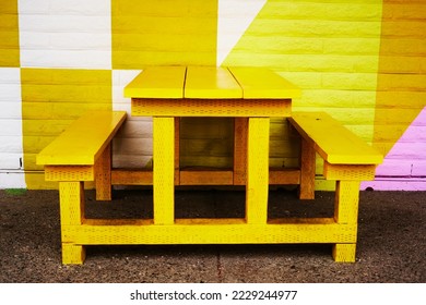                 yellow wooden bench is a perfect background. the color of fall season                  