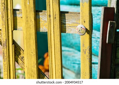 Yellow Wooden Fence, Wicket Gate With White Vintage Fittings