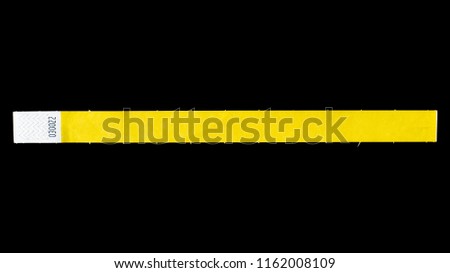 Yellow wristband for events, bracelet for concerts on black background
