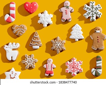 Yellow Xmas background. Gingerbread cookie pattern. Colorful winter holidays bakery food decor. Cute homemade biscuit collection festive composition for kids isolated on bright orange. - Powered by Shutterstock