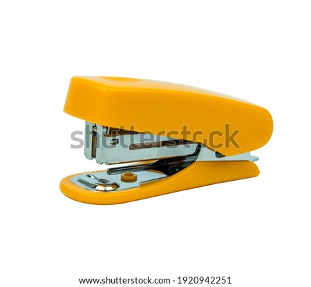 The yellow-colored stapler closes up on the white background. Clipping path.