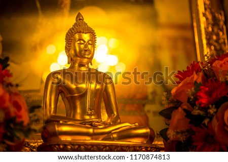 Yellow-gold Buddha and golden orange background make the Buddha look beautiful and beautiful.