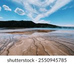 Yellowstone hot springs in Wyoming with blue sky and brown streaks