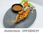 Yellowtail fish fried with seafood chili sauce offers a delightful fusion of crispy, golden-brown fish and a vibrant, spicy sambal that enhances its natural flavors