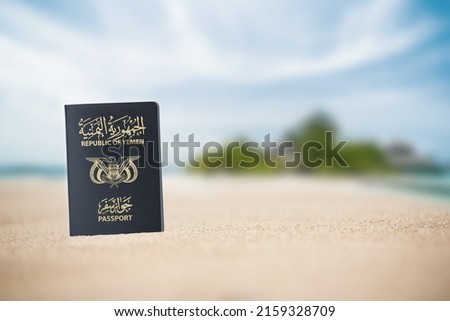 Yemeni passport on the beach sand ,Space for writing ,A Yemeni passport is a government document used by citizens of Yemen for international travel

