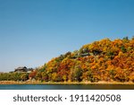 Yeongnamnu Korean traditional pavilion and autumn colorful mountain in Miryang, Korea