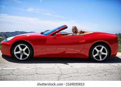 Yep, Shes Fast. Shot Of A Young Woman Driving In A Sports Car.