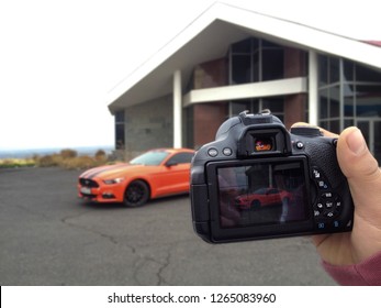 Yerevan, Armenia - 17 March 2018.
Crazy Orange Ford Mustang With Black Stripes Before Big Photoshoot. You Can See This Car Through Camera Viewfinder. 