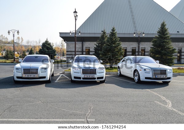 Yerevan, Armenia - 17\
November 2019.\
Lot of white Rolls-Royce standing next to luxury\
casino . You can see Phantoms, Ghosts and other white luxe cars\
under bright autumn sun.\
