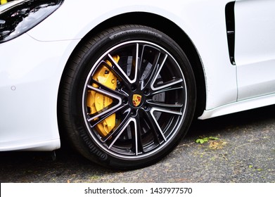 Yerevan, Armenia - 29 June 2019.
Pearl White Modern And Luxury Car Porsche Panamera's 21 Inches Chrome Rims With Big Yellow Brake Caliper. 