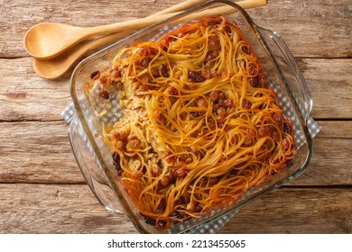 Yerushalmi Kugel A Traditional Eastern European Jewish Food Made Of Noodles And Burnt Sugar Close-up In A Glass Bowl On The Table. Horizontal Top View From Above
