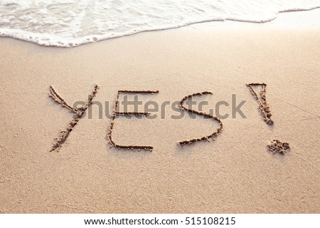 YES concept, positive changes in the life, word written on sand beach
