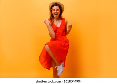 Yes, I done it! Excited cheerful female model with joyful expression, cheers and clenches fists, celebrates her success, has appealing look, poses against yellow studio background. Achievement - Shutterstock ID 1618044904