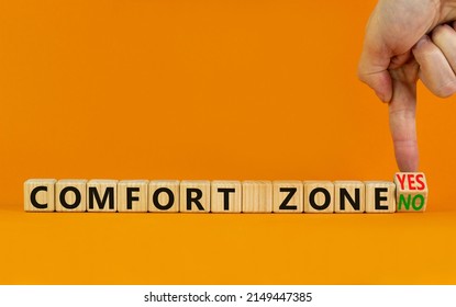 Yes or no comfort zone symbol. Businessman turns wooden cubes and changes words Comfort zone yes to Comfort zone no. Beautiful orange background, copy space. Business, psychology comfort concept. - Shutterstock ID 2149447385