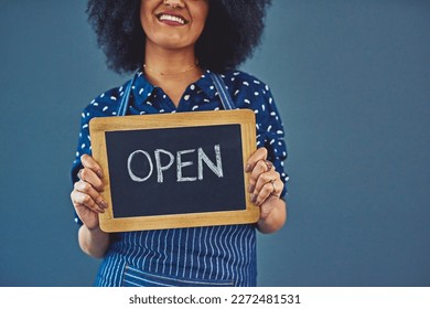 Yes, its official. Studio shot of a young woman holding a chalkboard with the word open on it against a gray background. - Powered by Shutterstock